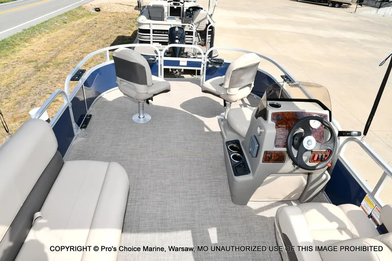 Slide: The Image of 2025 Sun Tracker Bass Buggy 16 XL Select pontoon boat interior with seating and steering console. - 5