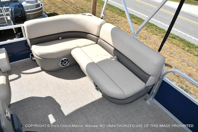 Slide: The Image of 2025 Sun Tracker Bass Buggy 16 XL Select pontoon boat with beige seating and speaker system. - 6