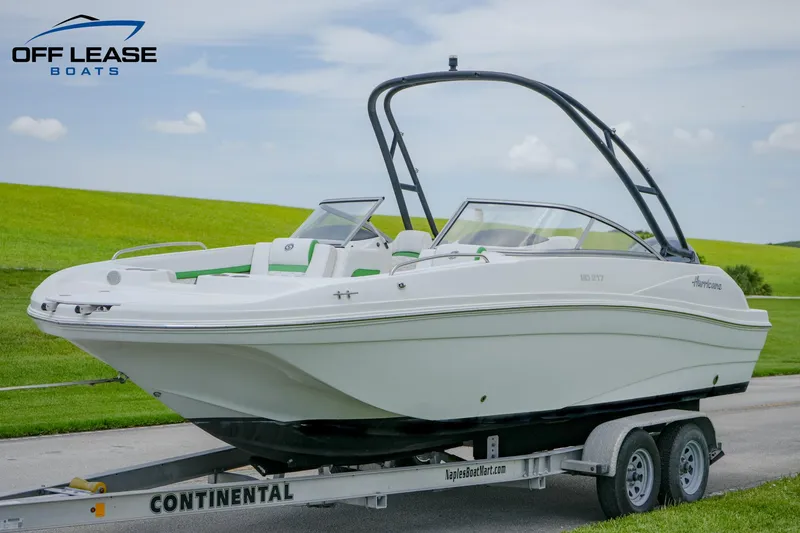 Slide: The Image of 2020 Hurricane 217 SD boat on trailer, displayed outdoors with green grass background. - 12
