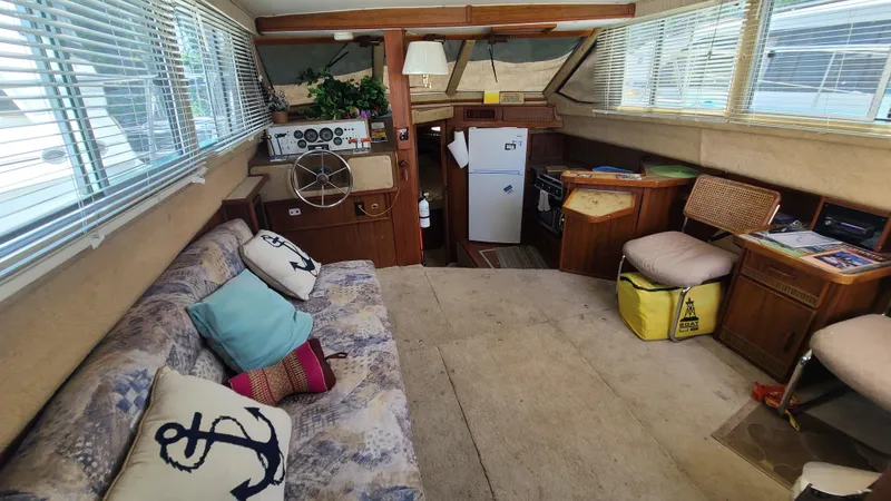 Slide: The Image of Interior of 1983 Sea Ray 360 Aft Cabin with cozy seating and nautical decor. - 10