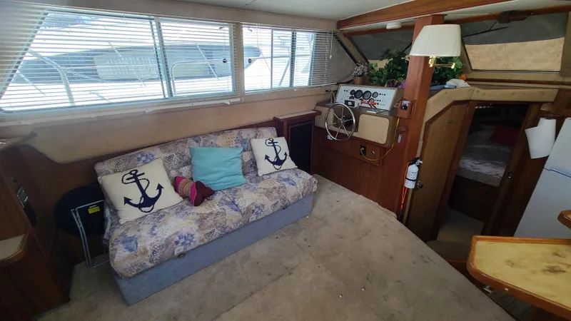 Slide: The Image of Interior of 1983 Sea Ray 360 Aft Cabin with nautical-themed decor and steering wheel. - 11