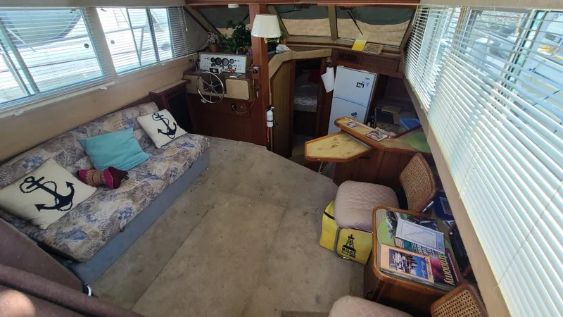 Slide: The Image of Interior of 1983 Sea Ray 360 Aft Cabin with cozy seating and nautical decor. - 9