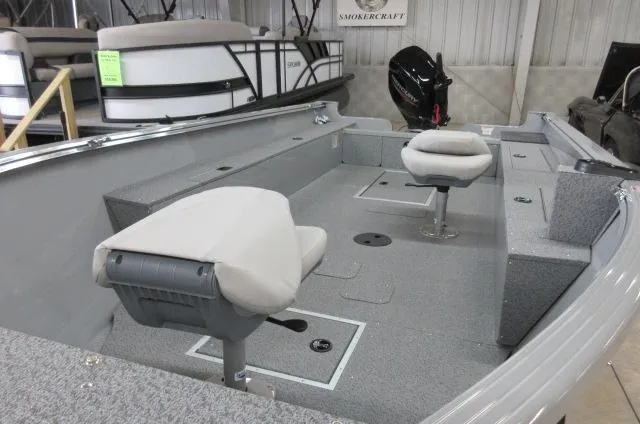 Slide: The Image of 2023 Smoker Craft Freedom 160 TL boat interior with seating and motor. - 2