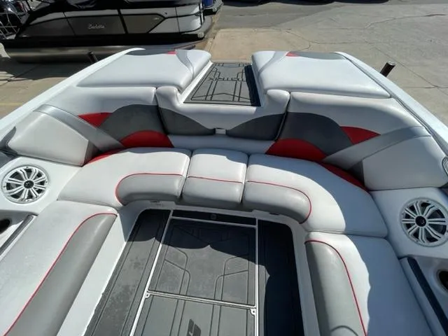 Slide: The Image of 2015 Sanger V 212 boat interior with gray and red cushioned seating. - 10
