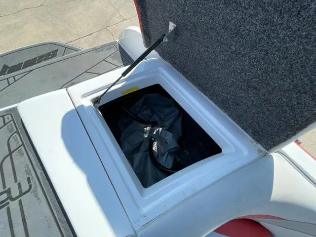 Slide: The Image of Open storage compartment of a 2015 Sanger V 212 boat. - 13