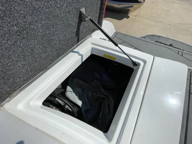 Slide: The Image of Open storage compartment on a 2015 Sanger V 212 boat. - 14