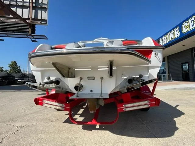 Slide: The Image of 2015 Sanger V 212 boat on a red trailer at a marine center. - 3