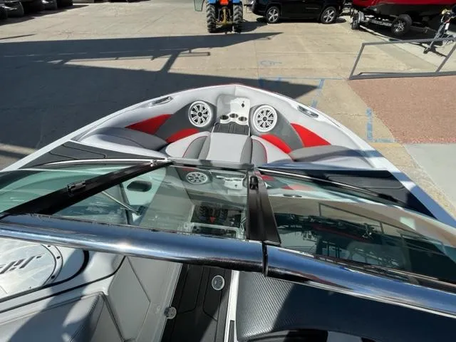 Slide: The Image of 2015 Sanger V 212 boat interior with red and gray seating and speakers. - 5