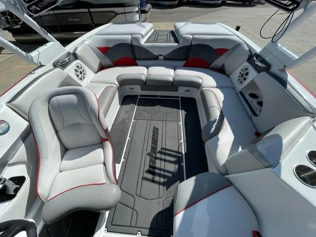 Slide: The Image of 2015 Sanger V 212 boat interior with gray and red seating, spacious layout. - 9