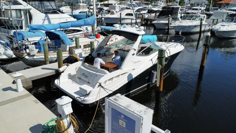 Slide: The Image of 2007 Sea Ray 310 Sundancer docked at marina with people onboard. - 10