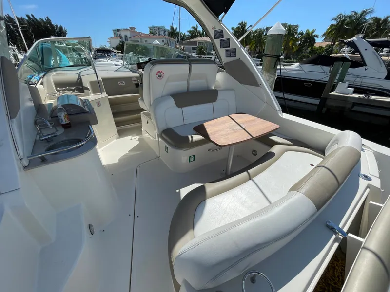 Slide: The Image of 2007 Sea Ray 310 Sundancer boat interior with seating and table, docked at marina. - 13