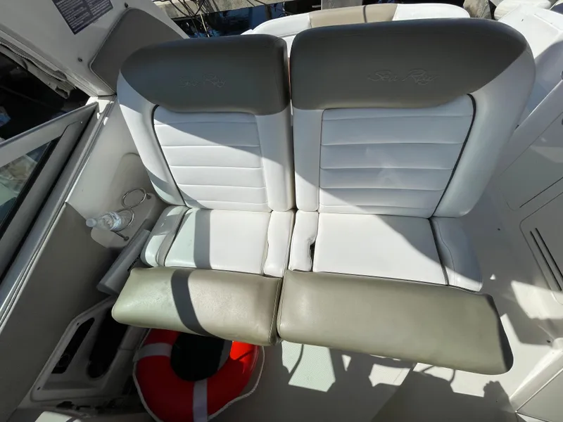 Slide: The Image of 2007 Sea Ray 310 Sundancer boat seating with life preserver and cup holder. - 18