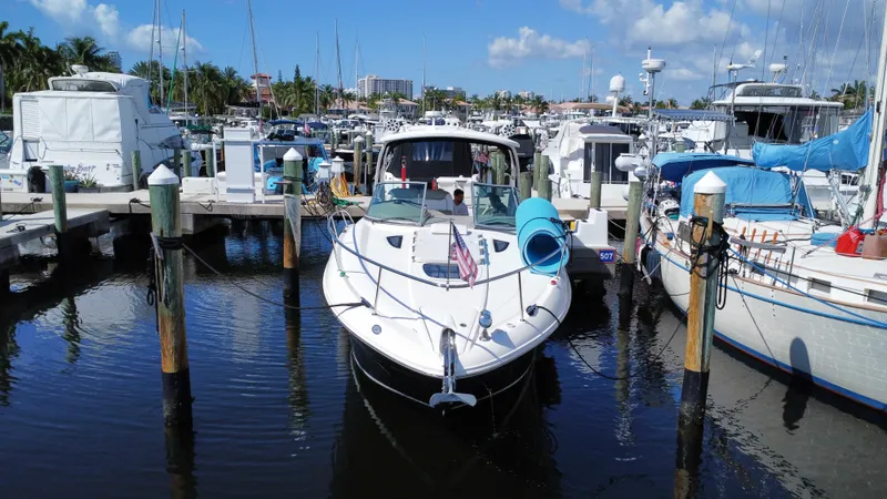 Slide: The Image of 2007 Sea Ray 310 Sundancer docked at a marina under a clear blue sky. - 2