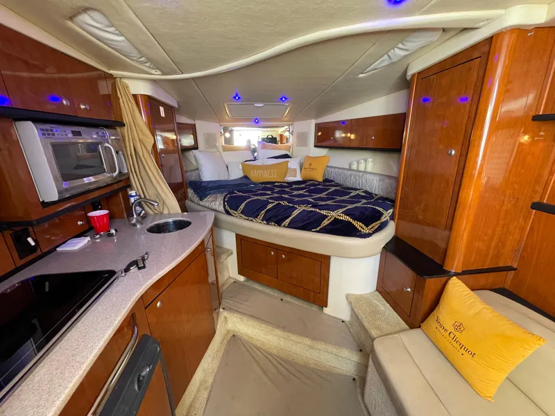Slide: The Image of Luxurious interior of 2007 Sea Ray 310 Sundancer yacht with cozy bed and kitchenette. - 24