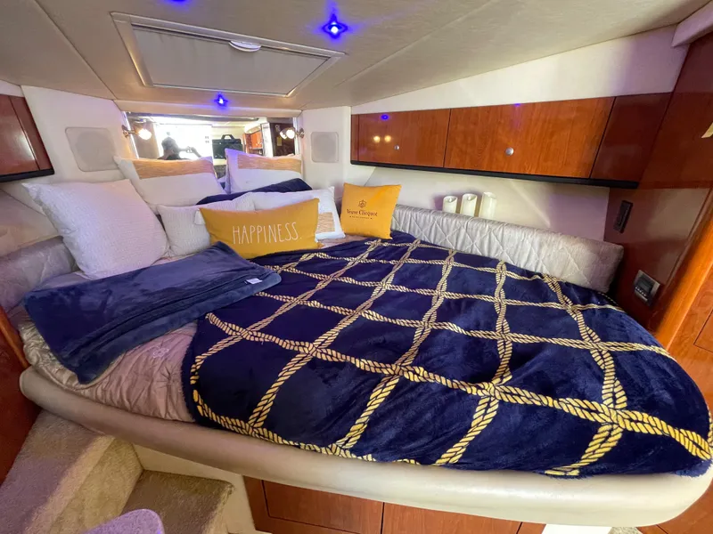 Slide: The Image of Luxurious 2007 Sea Ray 310 Sundancer cabin with cozy bedding and ambient lighting. - 26