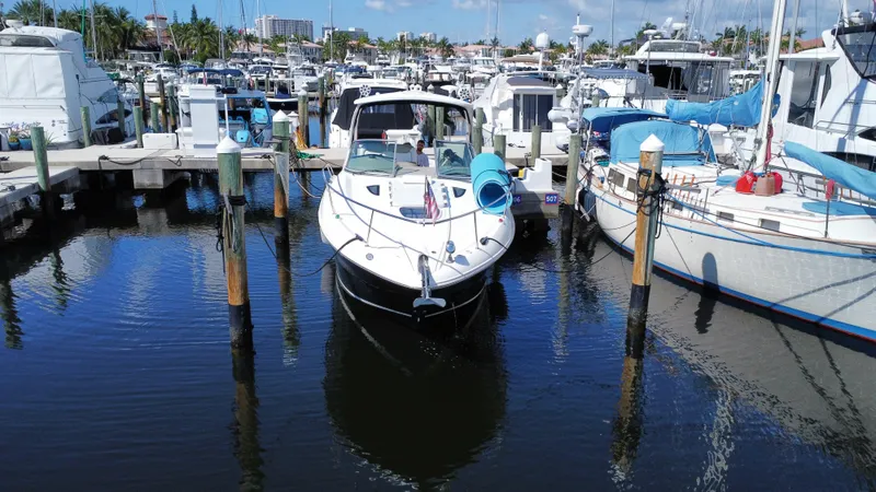 Slide: The Image of 2007 Sea Ray 310 Sundancer docked at a marina, surrounded by other boats. - 4