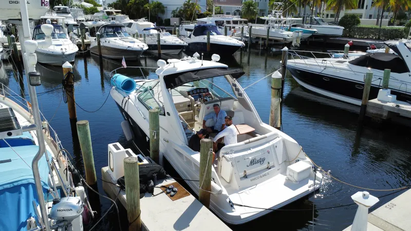 Slide: The Image of 2007 Sea Ray 310 Sundancer docked in a marina with other boats. - 8