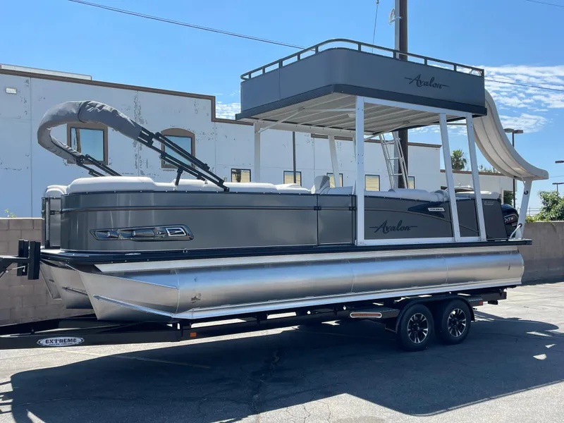 The Image of 2024 Avalon 2585 Catalina Funship pontoon boat on trailer, parked outdoors. - 0