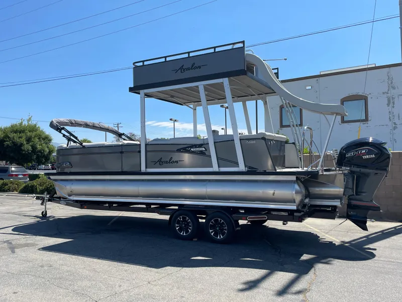 Slide: The Image of 2026 Avalon 2585 Catalina Funship pontoon boat with slide, parked on a trailer. - 3