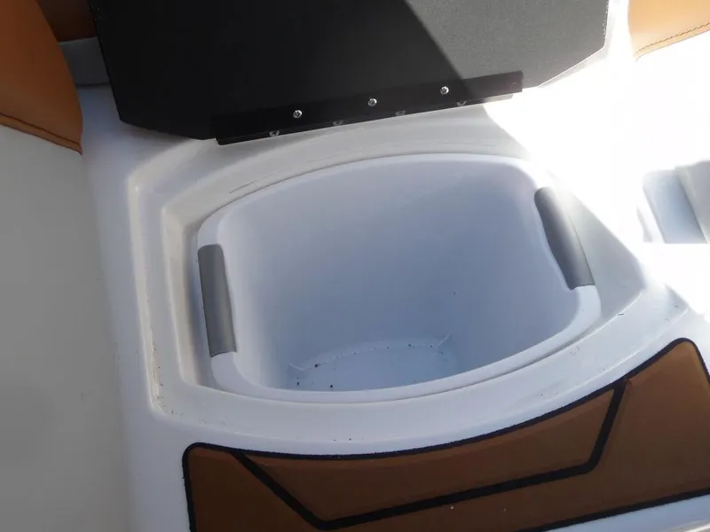 Slide: The Image of 2023 Malibu 21 LX boat storage compartment with open lid. - 11