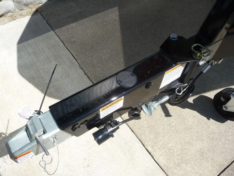 Slide: The Image of 2023 Malibu 21 LX trailer hitch and coupler on concrete driveway. - 12