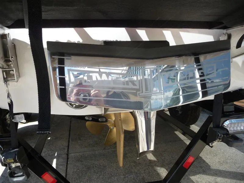 Slide: The Image of 2023 Malibu 21 LX boat stern with propeller and Power Wedge. - 17