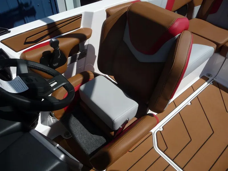 Slide: The Image of 2023 Malibu 21 LX boat interior with brown and red seating. - 7