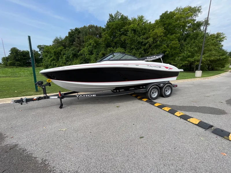 The Image of 2024 Tahoe 210 Si boat on a trailer in a parking lot. - 0