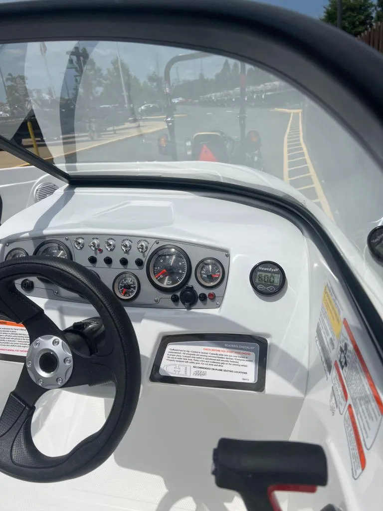 Slide: The Image of 2024 Tahoe 185 S boat dashboard with steering wheel and instrument panel. - 3