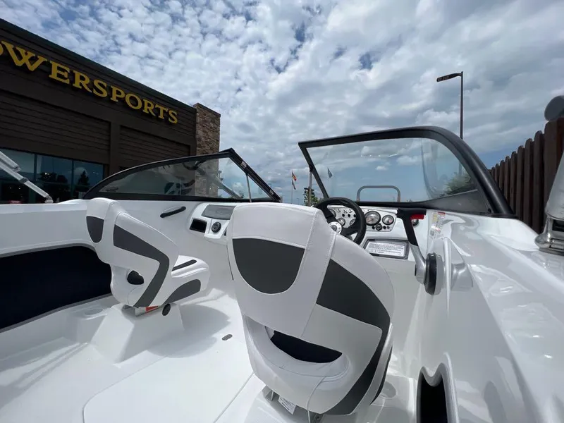 Slide: The Image of 2024 Tahoe 185 S boat interior with white and black seats, dashboard, and steering wheel. - 4