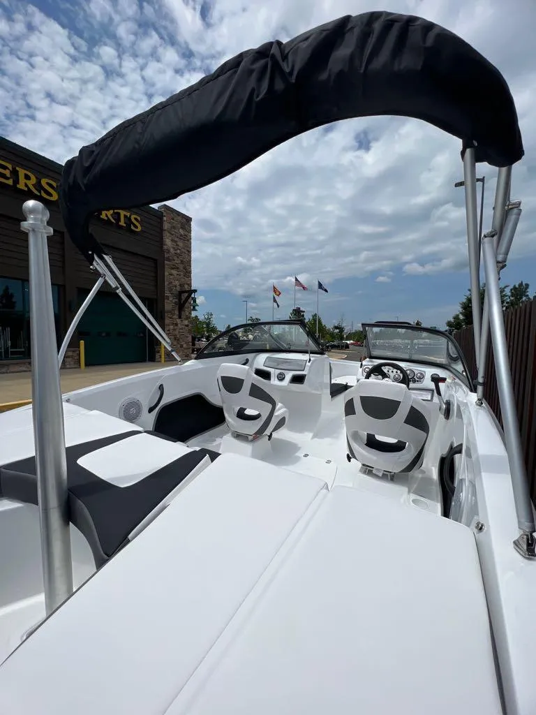 Slide: The Image of 2024 Tahoe 185 S boat with black canopy and white interior. - 5