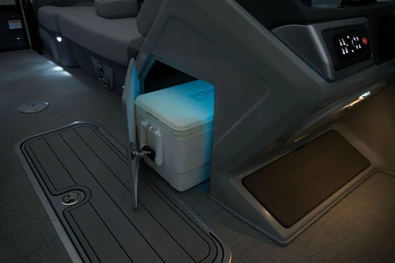 Slide: The Image of 2024 Regency 230 DL3 boat interior with illuminated storage compartment. - 29