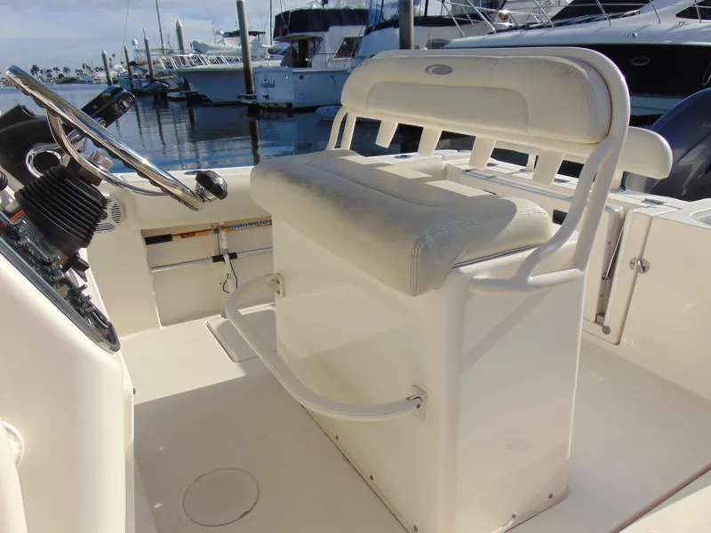 Slide: The Image of 2016 Cobia 237 Center Console boat interior with helm seat and steering wheel. - 14