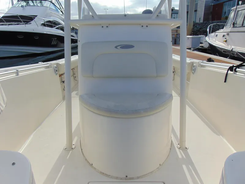 Slide: The Image of 2016 Cobia 237 Center Console boat interior with seating, docked at marina. - 15