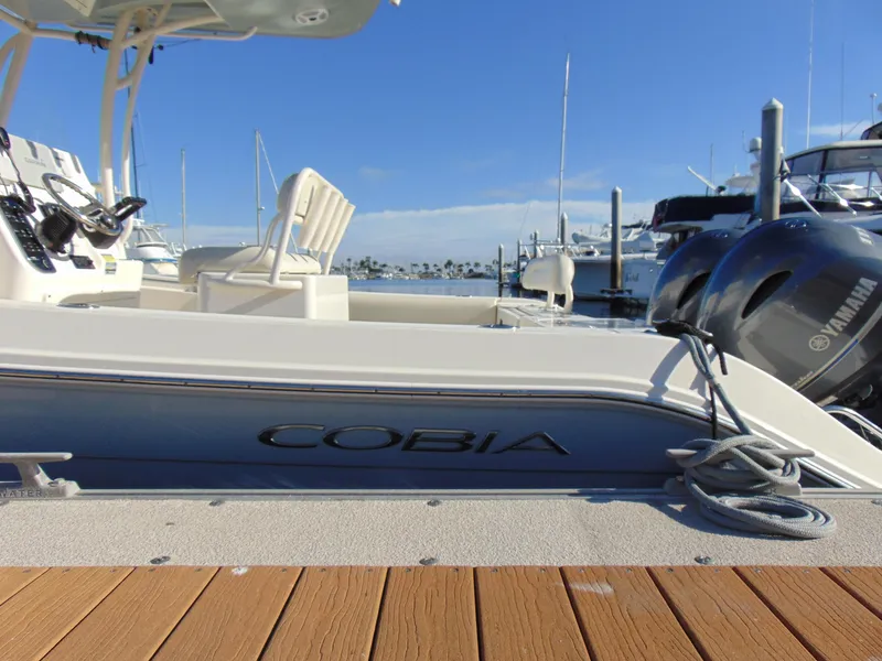 Slide: The Image of 2016 Cobia 237 Center Console boat docked with Yamaha engines. - 3