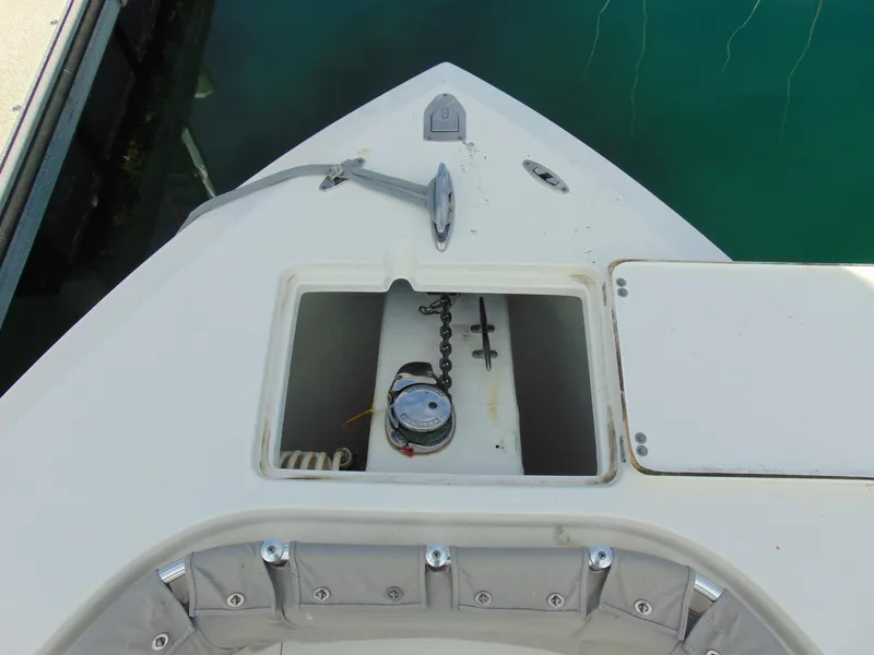 Slide: The Image of 2016 Cobia 237 Center Console boat anchor compartment with chain and winch. - 33