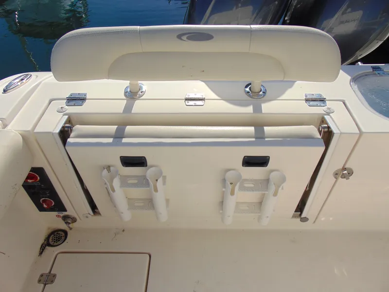 Slide: The Image of 2016 Cobia 237 Center Console boat with rod holders and storage compartment. - 35