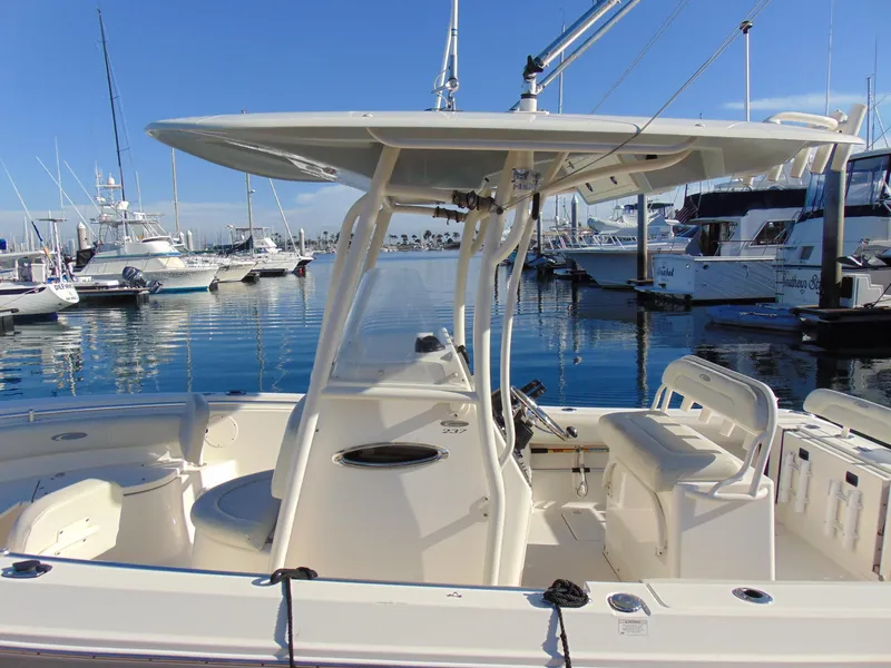 Slide: The Image of 2016 Cobia 237 Center Console boat docked in a marina. - 4