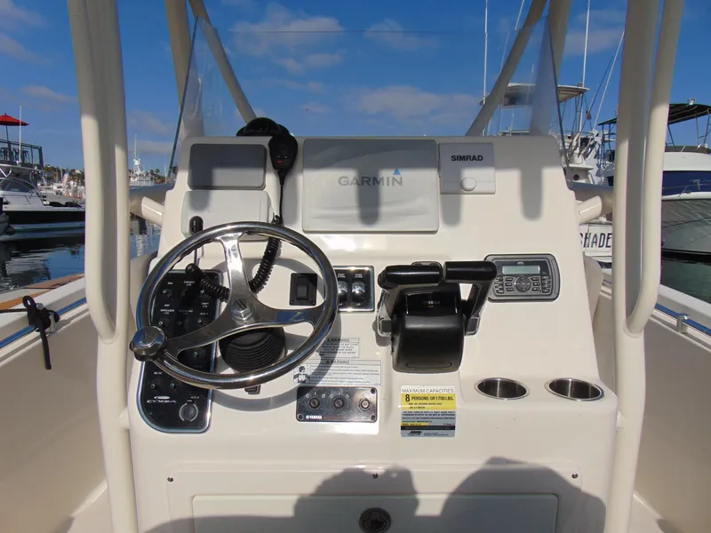 Slide: The Image of 2016 Cobia 237 Center Console helm with Garmin and Simrad electronics. - 7