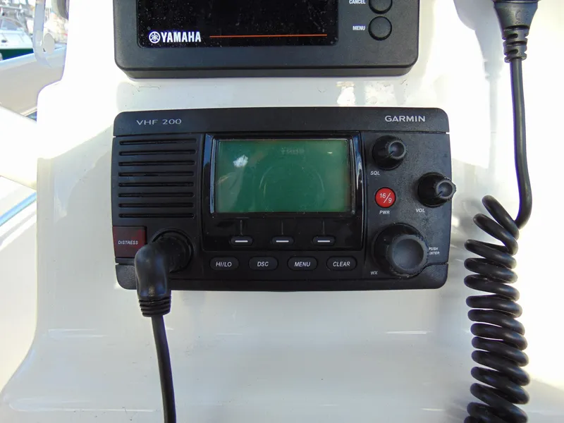 Slide: The Image of Garmin VHF 200 radio on 2016 Cobia 237 Center Console boat dashboard. - 8