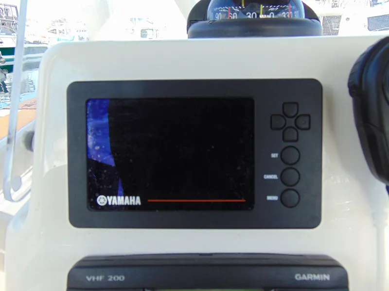 Slide: The Image of Yamaha display on 2016 Cobia 237 Center Console boat dashboard with Garmin VHF 200. - 9