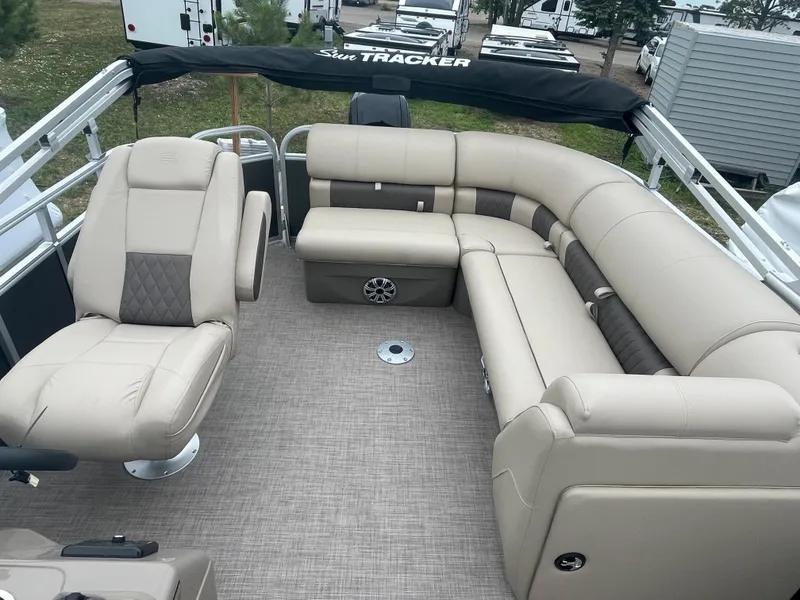 Slide: The Image of 2023 Sun Tracker Party Barge 20 DLX with beige seating and spacious deck layout. - 12