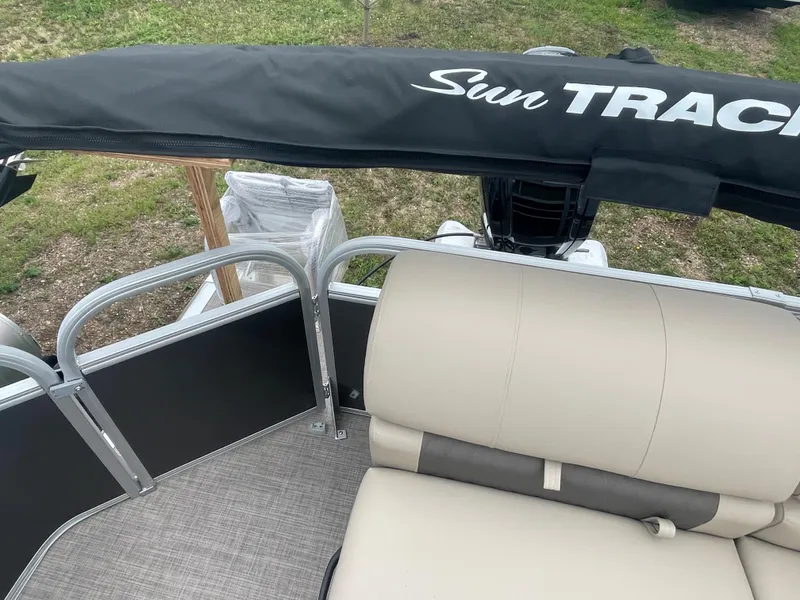 Slide: The Image of 2023 Sun Tracker Party Barge 20 DLX pontoon boat interior with seating and canopy. - 6