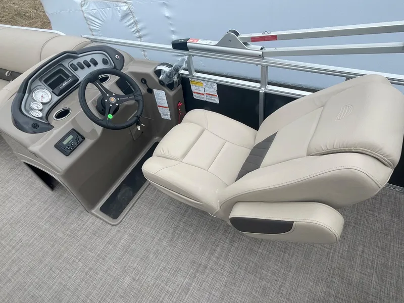 Slide: The Image of 2023 Sun Tracker Party Barge 20 DLX helm with beige captain's chair and control panel. - 8
