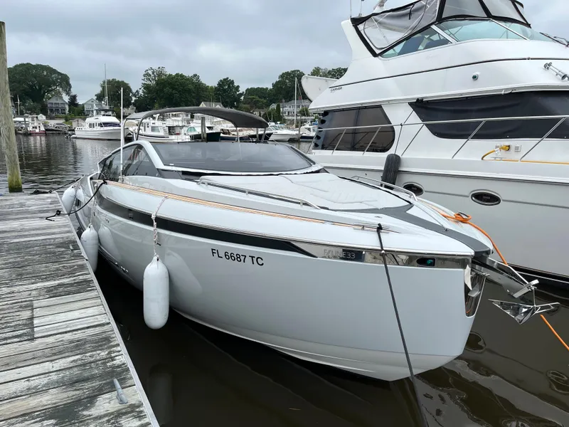 The Image of 2022 Fairline F//Line 33 yacht docked at marina, sleek design, white exterior. - 0