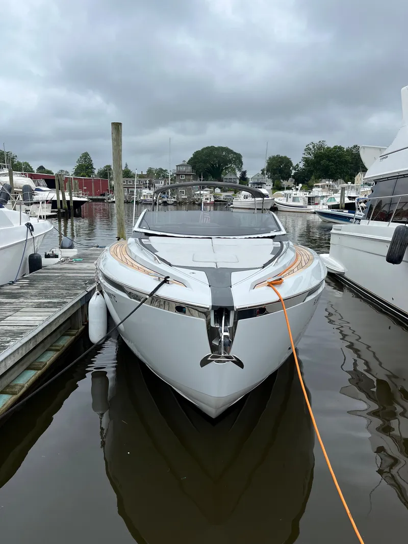 Slide: The Image of 2022 Fairline F//Line 33 yacht docked in a marina, overcast sky. - 1