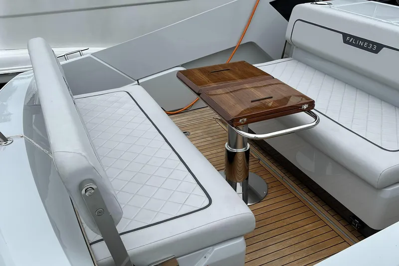 Slide: The Image of Luxury seating area on 2022 Fairline F//Line 33 yacht with wooden table. - 10