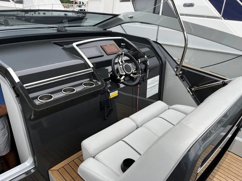 Slide: The Image of 2022 Fairline F//Line 33 yacht cockpit with modern steering and seating. - 16