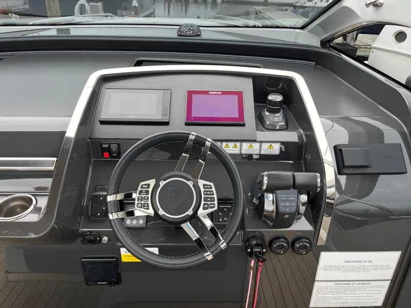 Slide: The Image of 2022 Fairline F//Line 33 helm with modern controls and navigation displays. - 17