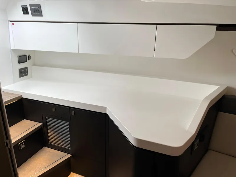 Slide: The Image of Modern interior of 2022 Fairline F//Line 33 yacht with sleek white cabinetry. - 23